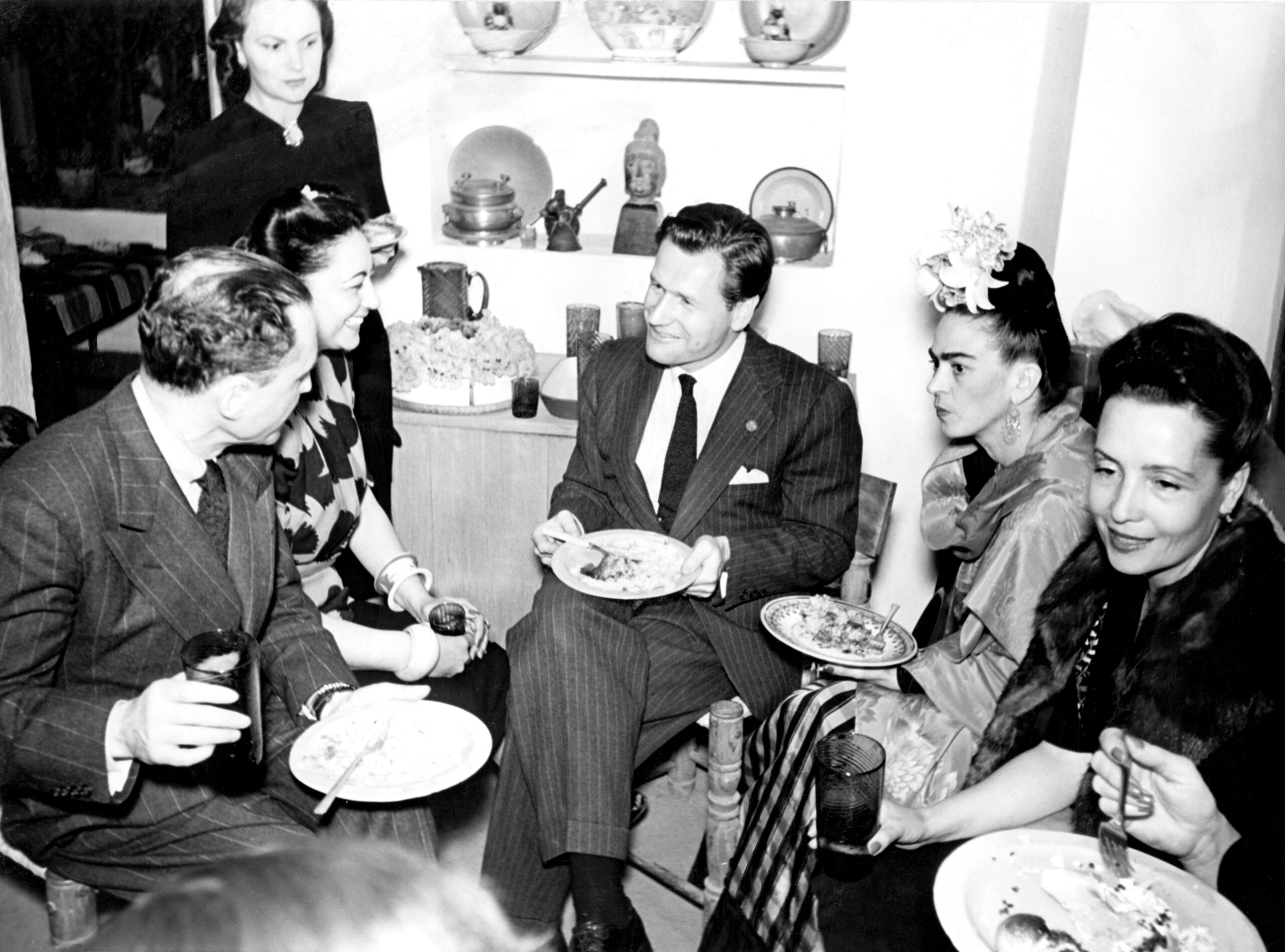 Nelson A. Rockefeller, Frida Kahlo, Miguel Covarrubias, and other guests gather for a meal in Mexico.